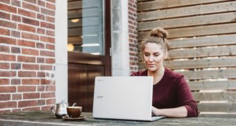 Woman at laptop outside