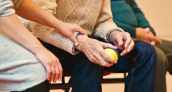 Hands of Elderly Man and Care Worker