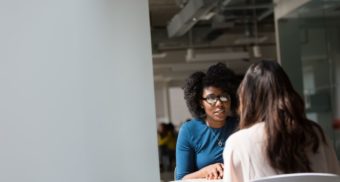 2 Female Professionals Communicating