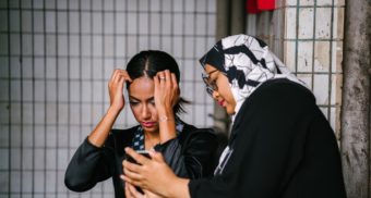 Woman Showing Woman Phone