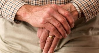 Hands Folded on Cane