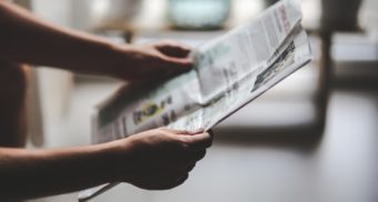 person holding a newspaper