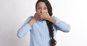 Woman Covering Mouth