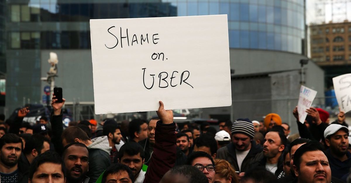 Strikers Holding Sign Stating Shame on Uber