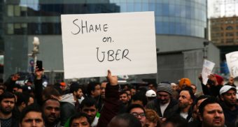 Strikers Holding Sign Stating Shame on Uber