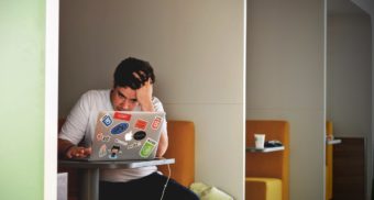 CEWS Stressed Worker at laptop