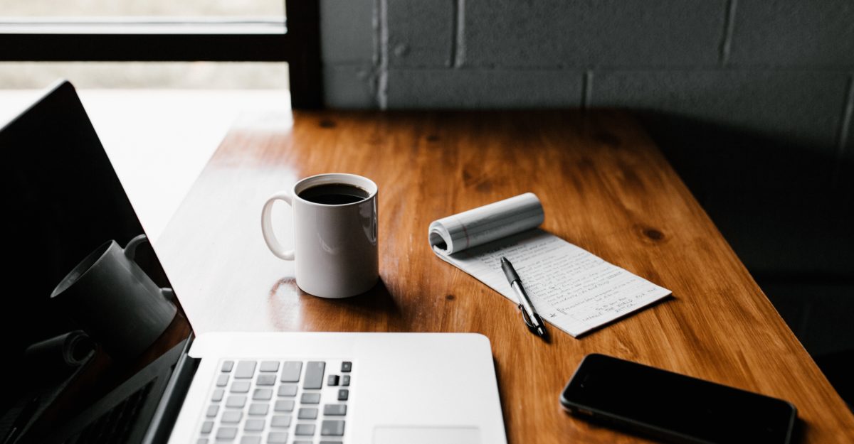 Home Office Laptop, Notepad, and Coffee