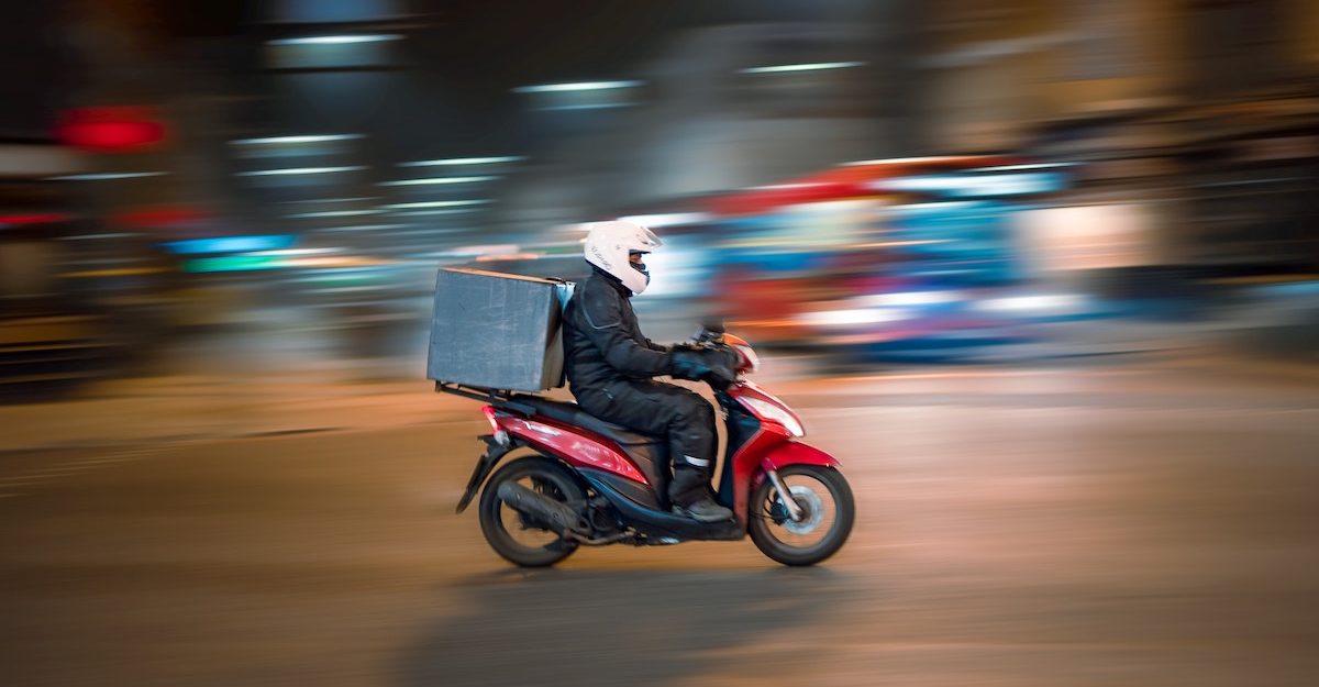 A person conducts food deliveries on their moped. Skip The Dishes employees are entitled to full severance pay when they lose their job.