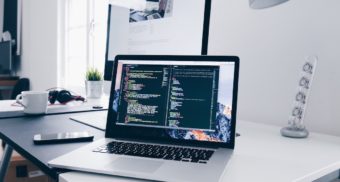 A laptop displays coding in various windows. Salesforce Canada employees are entitled to severance when they lose their job.