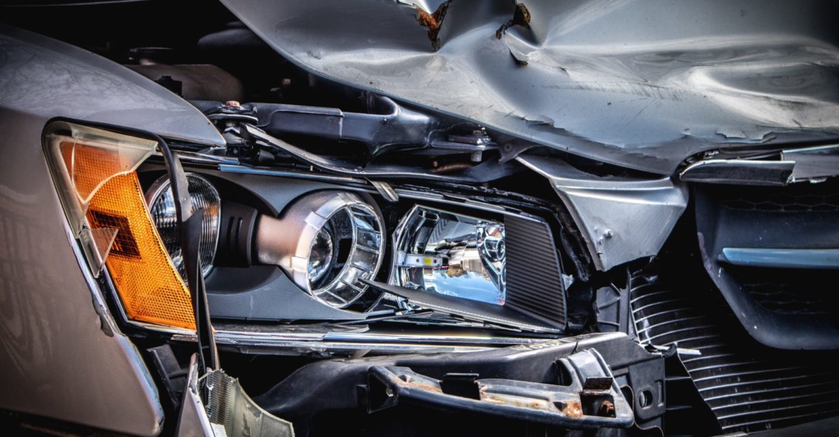 A photo of significant damage to the front of a grey vehicle.