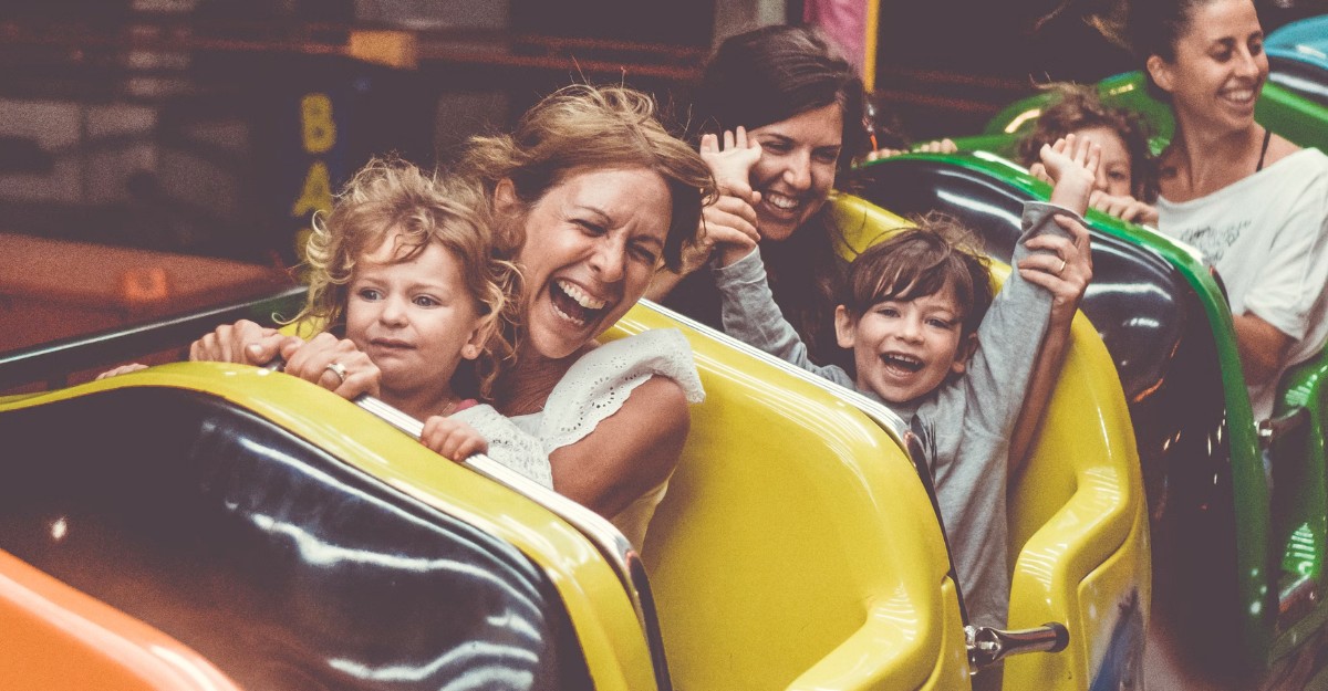 A photo of parents with their children on a rollercoaster. (Photo: Chris Slupski / Unsplash)