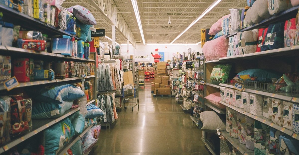 An aisle in a big box store featuring an assortment of items and home decor. Walmart employees are entitled to full severance when they lose their job.