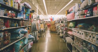 An aisle in a big box store featuring an assortment of items and home decor. Walmart employees are entitled to full severance when they lose their job.