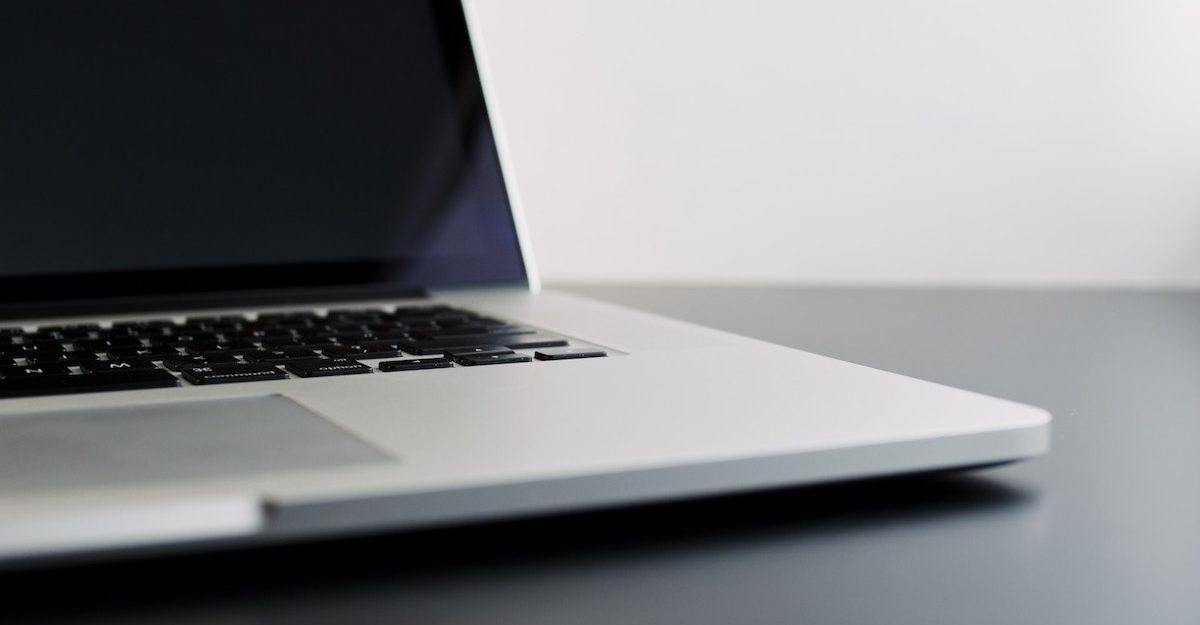 An grey laptop sits open on a desk. Dropbox employees are entitled to severance pay when they lose their job.