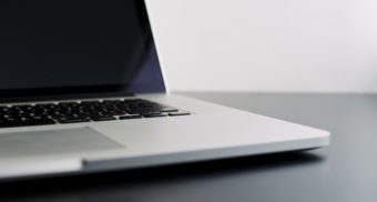 An grey laptop sits open on a desk. Dropbox employees are entitled to severance pay when they lose their job.