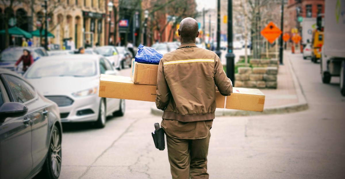 A photo of a person delivering packages. (Photo: Maarten van den Heuvel / Unsplash)