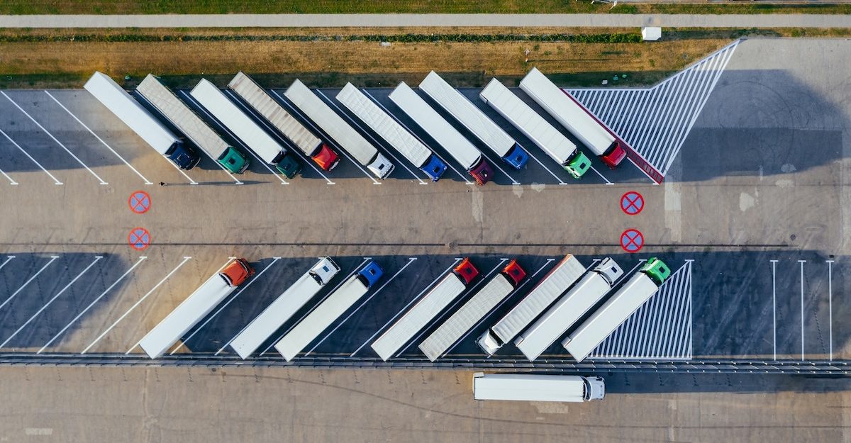 Dozens of tractor trailers sit in a large parking lot, ready to make their deliveries. WESCO Canada employees are entitled to full severance when they lose their jobs.