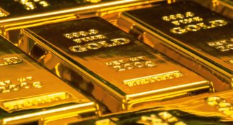 Multiple bars of gold placed side by side. B2Gold is a Canadian gold-producer.