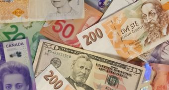 An assortment of currency from around the world. Canadian Western Bank employees are entitled to severance pay when they lose their job.