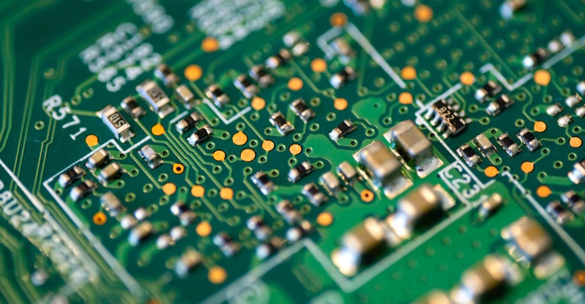A photo of a green and white circuit board. (Photo: Magnus Engø / Unsplash)