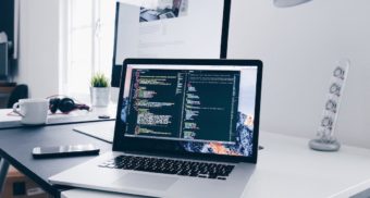 A laptop displays coding in various windows. ByteDance employees working in Canada are entitled to severance when they lose their job.