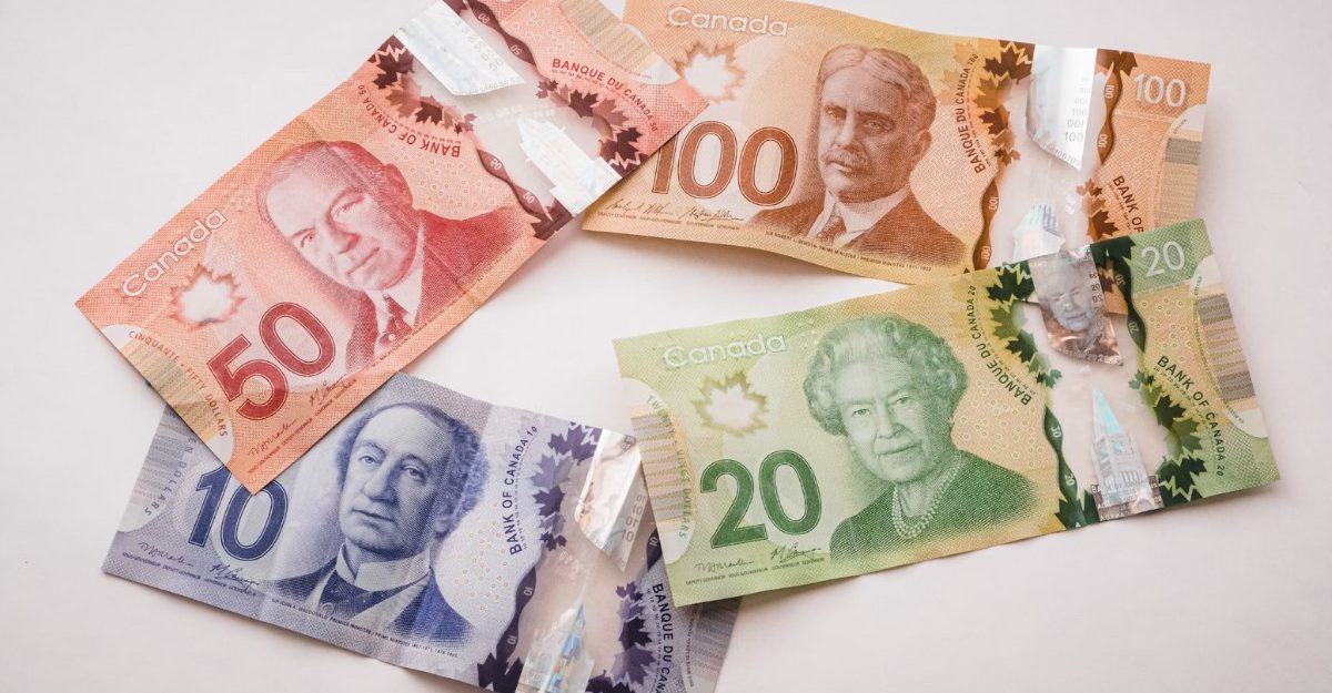 A photo of four Canadian bills on a table. (Photo: PiggyBank / Unsplash)
