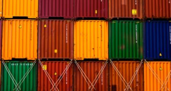 A photo of shipping containers in various colours. (Photo: Ishant Mishra / Unsplash)