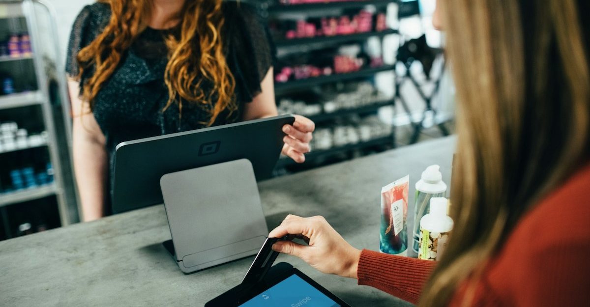 A customer uses a digital terminal to pay for their purchase.