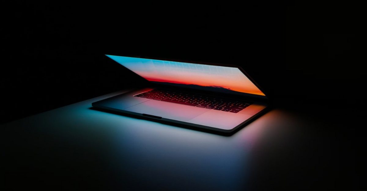 A photo of a laptop with a colourful screensaver. (Photo: Ales Nesetril / Unsplash)