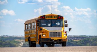 A lone yellow school bus, like the ones used by OSTA.