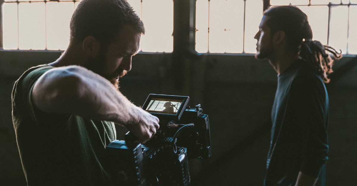 A photo of a person filming an actor with a camera. (Photo: Jakob Owens / Unsplash)