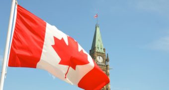 The Canadian flag waves in front of the Centre Block on Parliament Hill on Canada Day in Ontario.