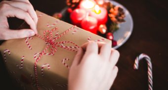 A present is tied with a candy cane themed-string, ready to be delivered on Christmas Day.