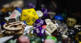 A photo of various types of dice on a table. (Photo: Nika Benedictova / Unsplash)