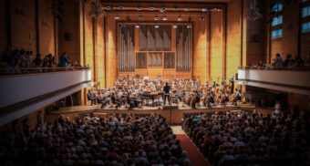 An orchestra performing in a concert hall, like the OSO led by Rosemary Thomson.