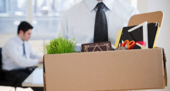 A worker leaving the office with his supplies. (Photo: The Balance Careers)