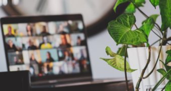 A photo of a laptop hosting a video conference call with staff members. (Photo: Sigmund / Unsplash)