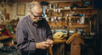 A photo of a person wrapping a thread around a wooden tool. (Photo: Carter Yocham / Unsplash)