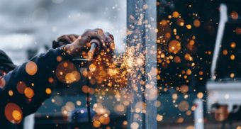 A photo of a person operating a piece of machinery. (Photo: Christopher Burns / Unsplash)