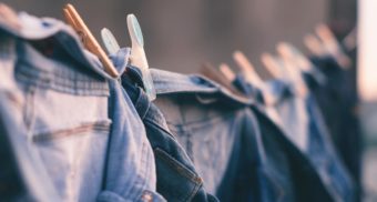 A photo of denim clothing on a clothes line. (Photo: Bruno Nascimento / Unsplash)