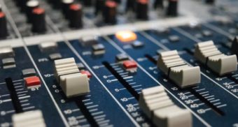 A close-up photo of a DJ mixer. (Photo: Alexey Ruban / Unsplash)