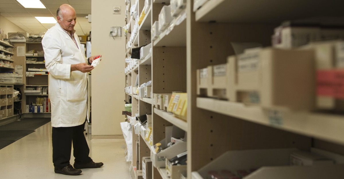 A photo of a pharmacist looking at a specific prescription. (Photo: National Cancer Institute / Unsplash)