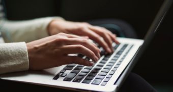 A photo of a person typing on a laptop. (Photo: Kaitlyn Baker / Unsplash)