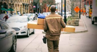 A photo of a person delivering packages. (Photo: Maarten van den Heuvel / Unsplash)