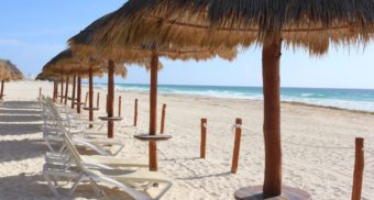 A photo of lounge chairs at a beach in Cancún, Mexico. (Photo: Alex Zakharchenko / Unsplash)