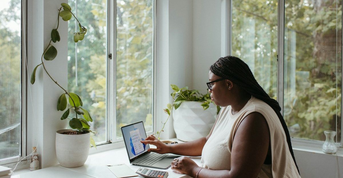 A woman comfortably working from home.