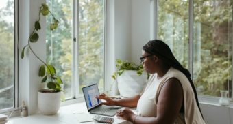 A woman comfortably working from home.