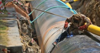 A photo of a person helping to build a pipeline. (Photo: SELİM ARDA ERYILMAZ / Unsplash)