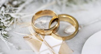 A photo of gold rings on a table. (Photo: Sandy Millar / Unsplash)
