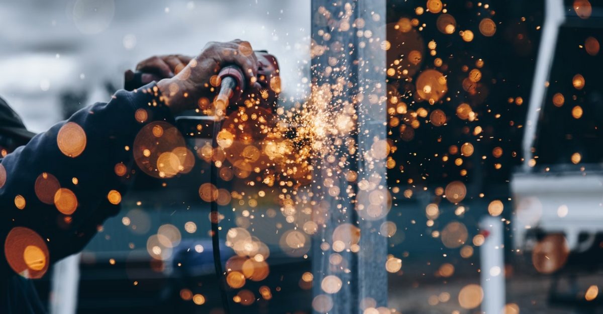 A photo of a person operating a piece of machinery. (Photo: Christopher Burns / Unsplash)